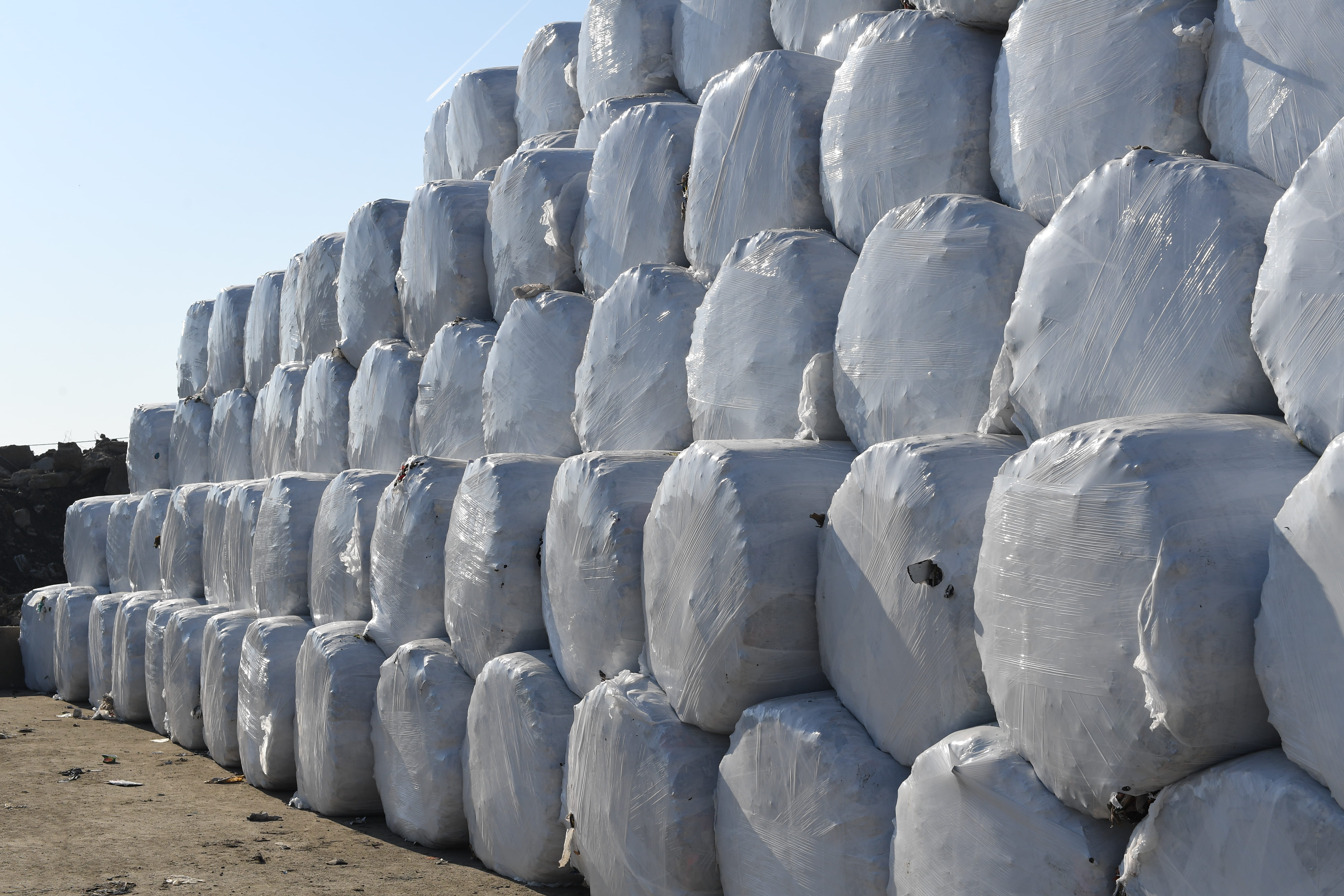 A stack of white round bales.
